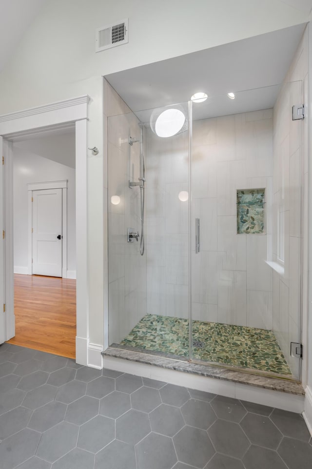 bathroom featuring tile patterned flooring and a shower with door