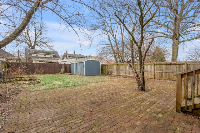 view of yard with a storage shed and a patio area