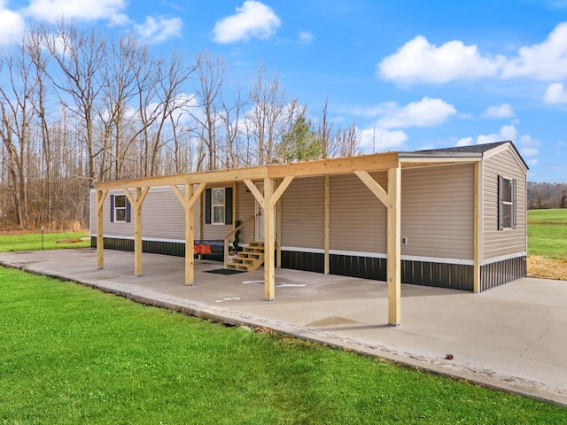 exterior space with a lawn and a carport