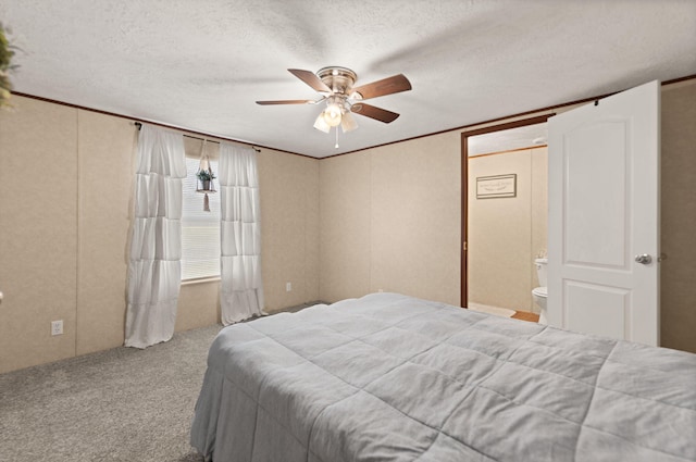 bedroom with ensuite bath, ceiling fan, ornamental molding, a textured ceiling, and light carpet