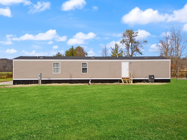 rear view of property with a yard