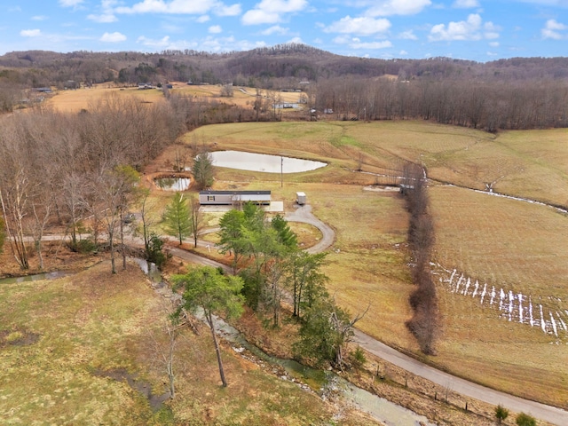 birds eye view of property featuring a water view and a rural view