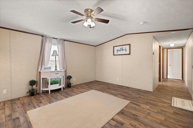 interior space with dark hardwood / wood-style flooring, a textured ceiling, crown molding, and ceiling fan