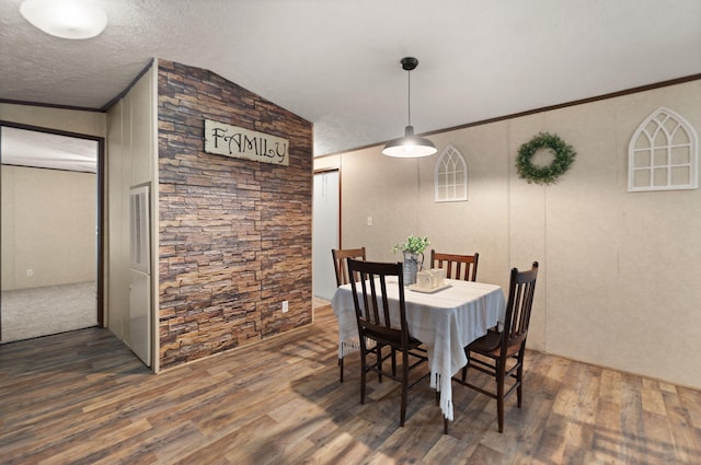 dining area featuring crown molding, lofted ceiling, and dark hardwood / wood-style flooring