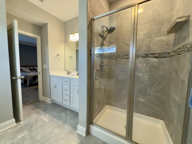 ensuite bathroom featuring baseboards, ensuite bath, a stall shower, and vanity