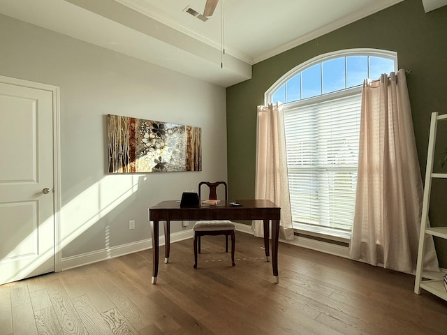 office space featuring crown molding, wood finished floors, visible vents, and a healthy amount of sunlight