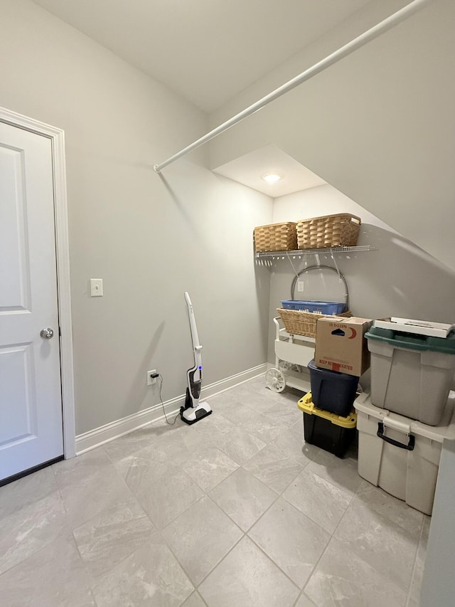 washroom with baseboards