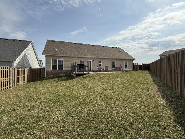 back of property with a patio, a yard, a fenced backyard, and brick siding