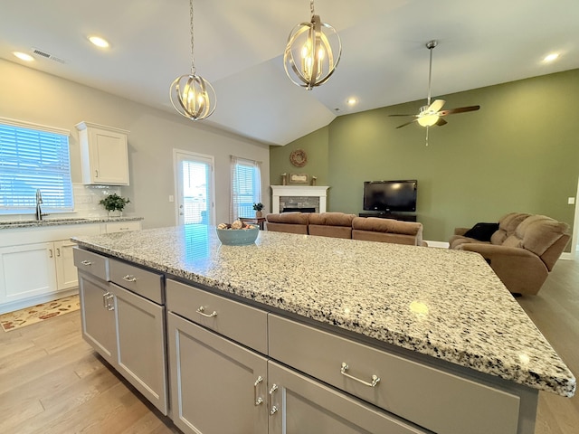 kitchen with a ceiling fan, visible vents, a wealth of natural light, and a sink