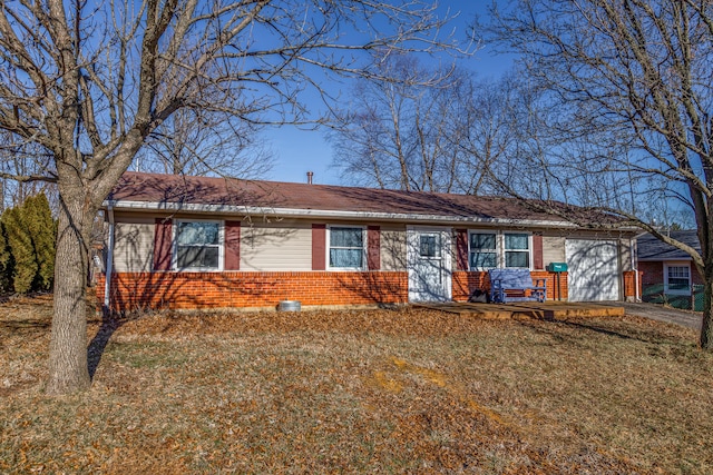 single story home featuring a garage and a front lawn