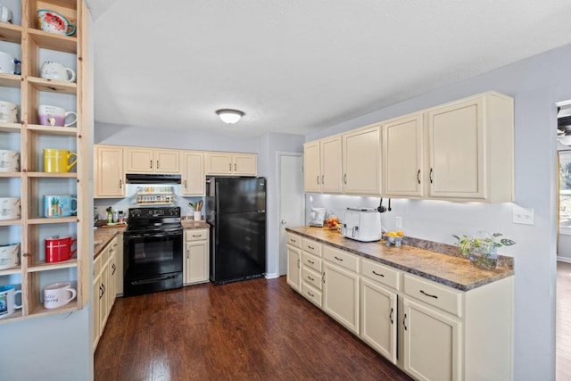 kitchen featuring cream cabinets, dark hardwood / wood-style floors, and black appliances