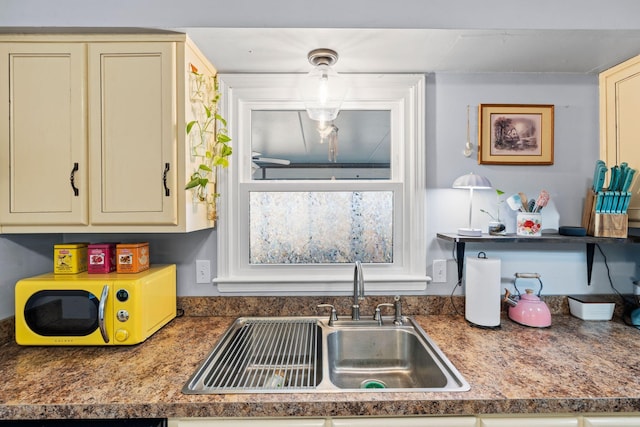 kitchen featuring sink and cream cabinets