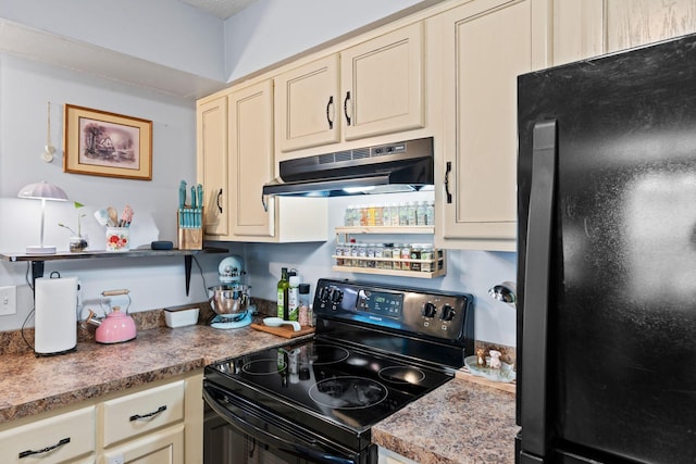 kitchen with black appliances and cream cabinetry