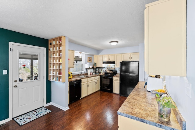 kitchen with sink, a textured ceiling, dark hardwood / wood-style flooring, and black appliances