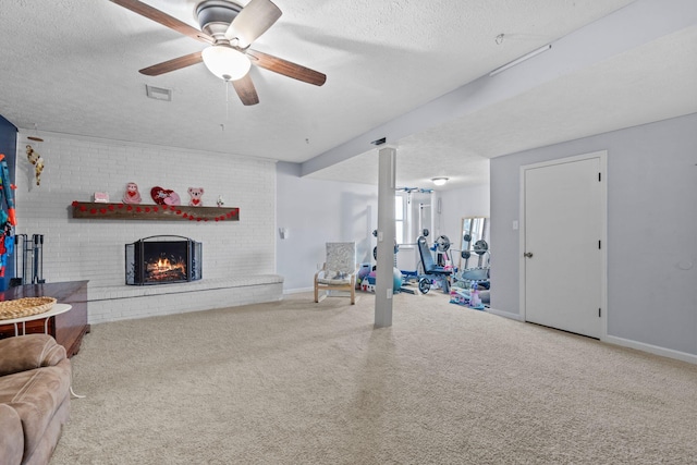 living room featuring ceiling fan, a brick fireplace, carpet, and a textured ceiling