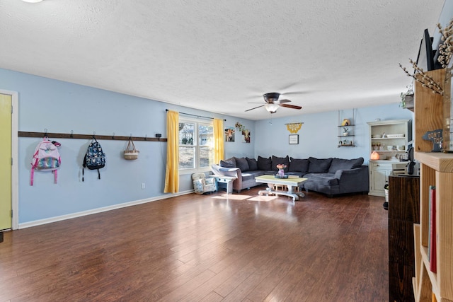 living room with dark hardwood / wood-style flooring, a textured ceiling, and ceiling fan