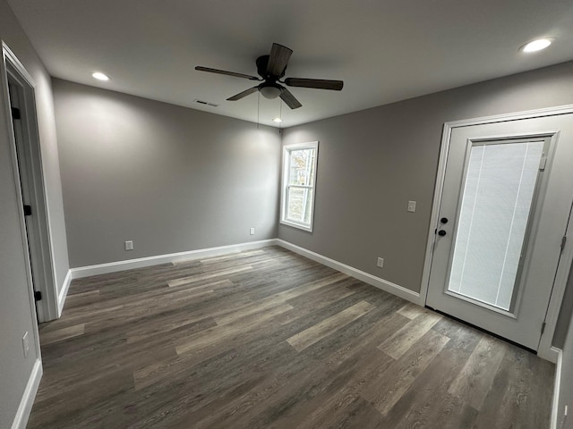 interior space with dark wood-type flooring and ceiling fan