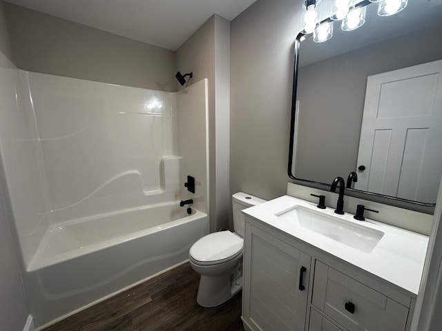 full bathroom featuring vanity, hardwood / wood-style flooring,  shower combination, and toilet