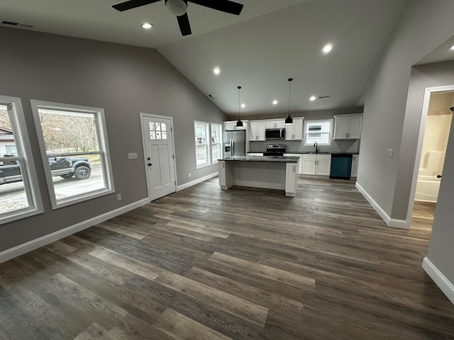 kitchen featuring sink, white cabinetry, a center island, appliances with stainless steel finishes, and pendant lighting