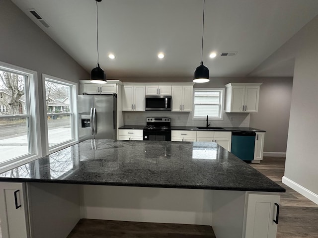 kitchen featuring pendant lighting, sink, appliances with stainless steel finishes, white cabinets, and a kitchen island