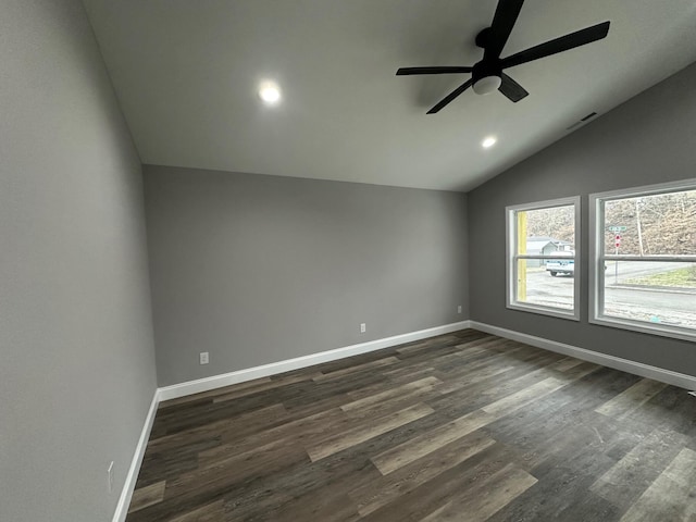 unfurnished room featuring lofted ceiling, dark hardwood / wood-style floors, and ceiling fan