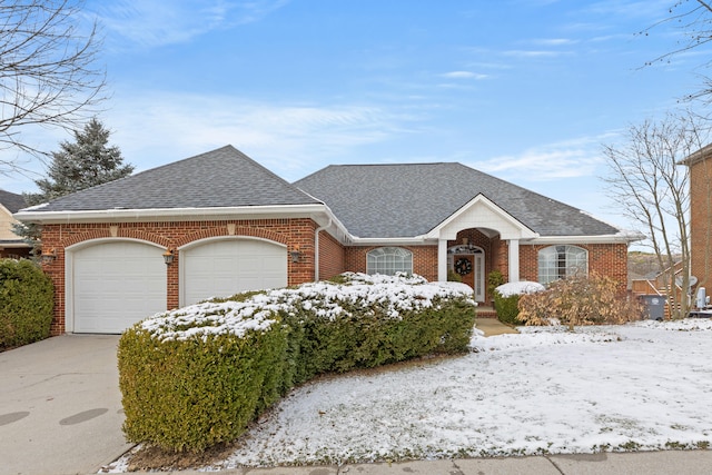 view of front of home with a shingled roof, brick siding, driveway, and a garage