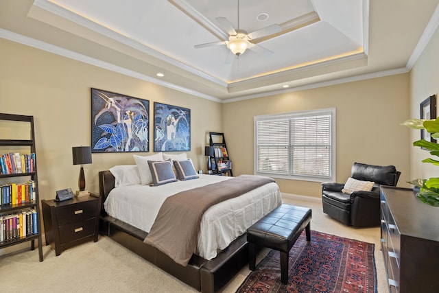 bedroom featuring a raised ceiling, light colored carpet, crown molding, and ceiling fan