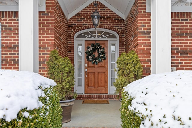 view of exterior entry with brick siding