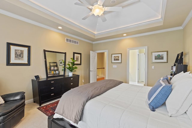 bedroom with crown molding, a raised ceiling, light colored carpet, visible vents, and baseboards