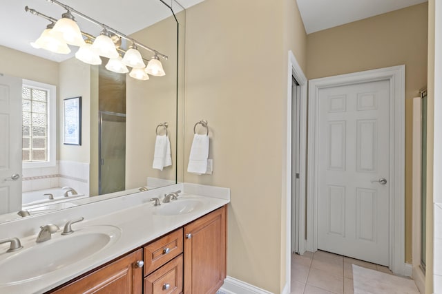 full bathroom featuring a shower stall, double vanity, a sink, and tile patterned floors