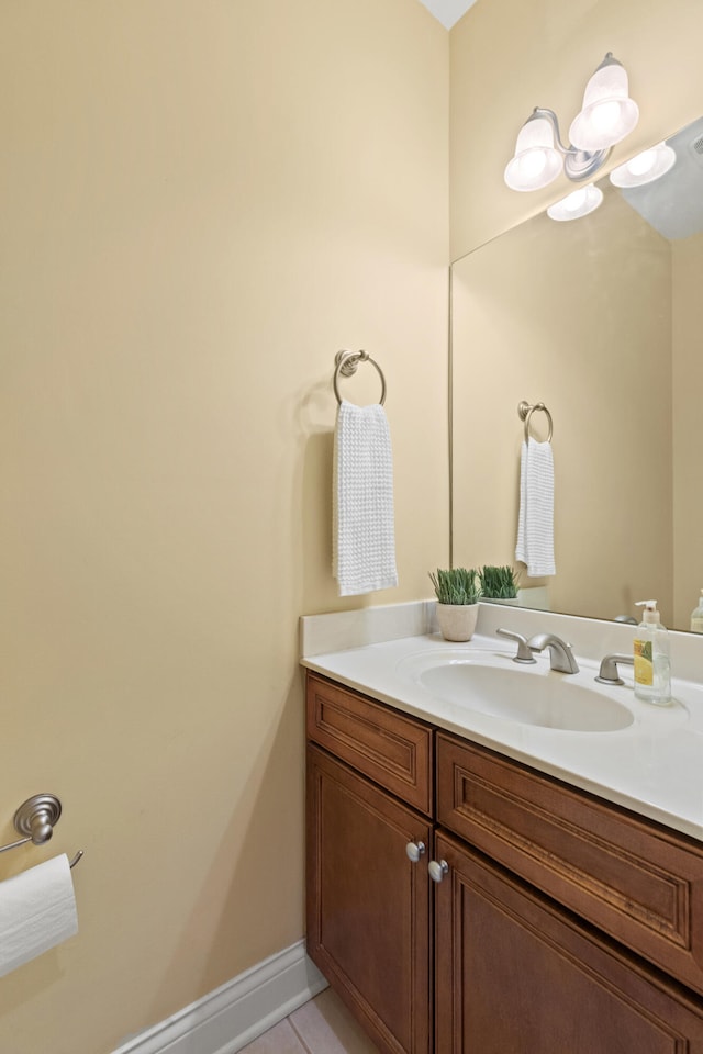 bathroom with vanity, baseboards, and tile patterned floors