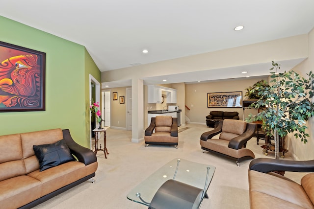 living room featuring recessed lighting, baseboards, and light colored carpet