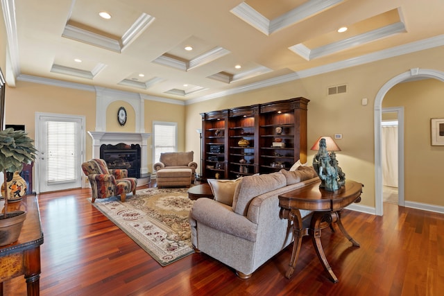 living room featuring a healthy amount of sunlight, a large fireplace, visible vents, and arched walkways