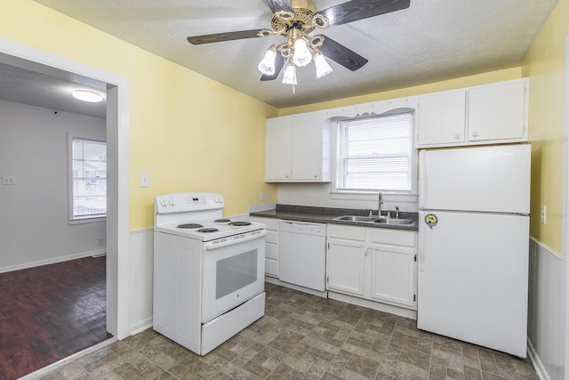 kitchen with sink, white cabinetry, a textured ceiling, ceiling fan, and white appliances