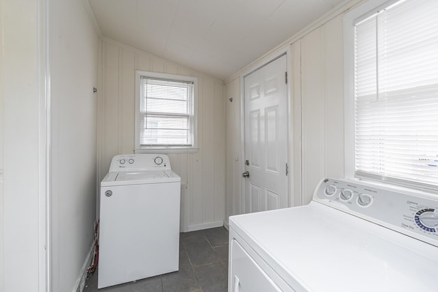 laundry room with dark tile patterned flooring and independent washer and dryer