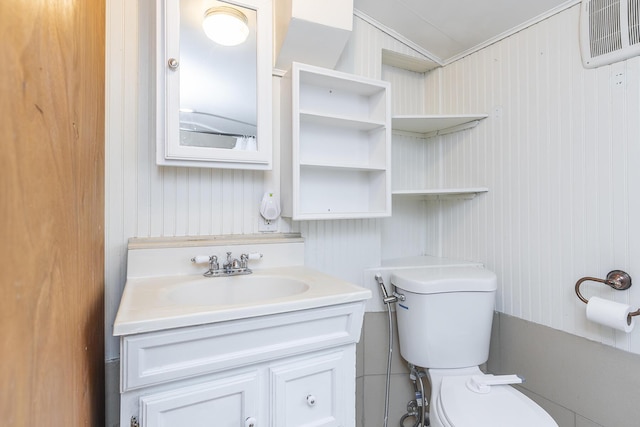 bathroom featuring vanity, lofted ceiling, and toilet