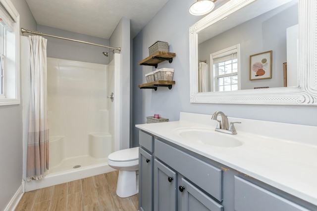 bathroom featuring toilet, hardwood / wood-style floors, vanity, and a shower with curtain