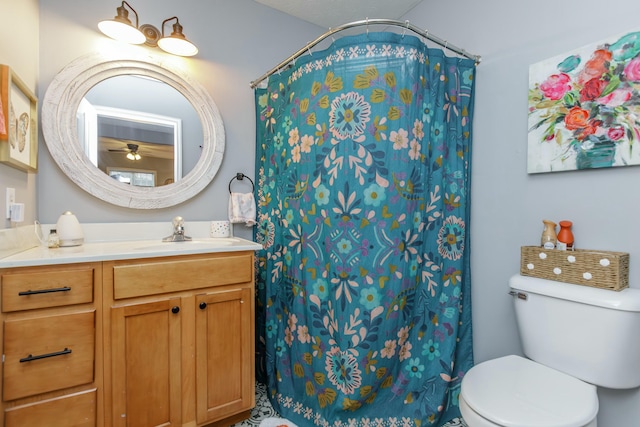 bathroom with vanity, a shower with shower curtain, and toilet