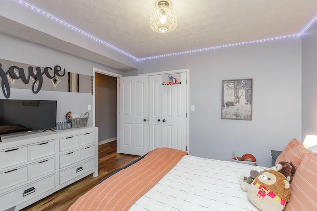 bedroom featuring hardwood / wood-style flooring, a closet, and a textured ceiling