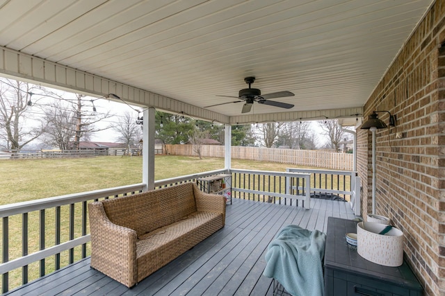 deck with a yard and ceiling fan