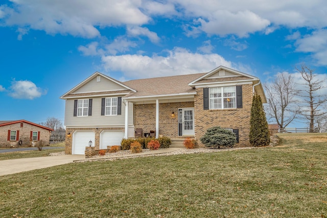 bi-level home featuring a garage and a front lawn