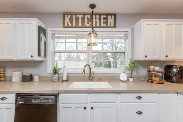 kitchen featuring dishwasher, sink, and white cabinets