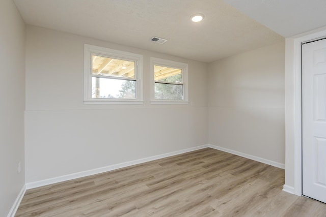 unfurnished room with light hardwood / wood-style flooring