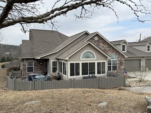 rear view of house featuring a garage