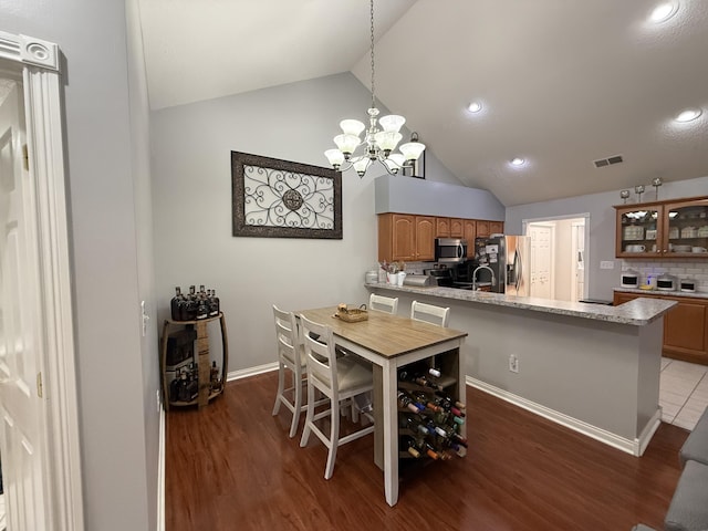 403 Chateau Pl, Bronston, KY 42518 - dining space featuring an inviting chandelier, lofted ceiling, and dark hardwood / wood-style flooring