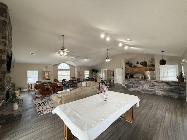 403 Chateau Pl, Bronston, KY 42518 - dining area featuring dark wood-type flooring, a stone fireplace, vaulted ceiling, a textured ceiling, and ceiling fan