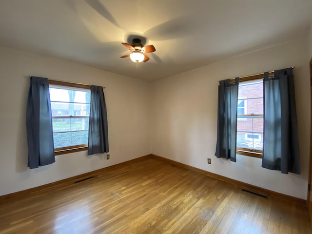 unfurnished room with wood-type flooring and ceiling fan