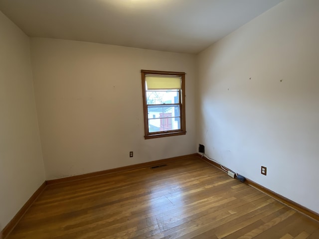 unfurnished room with wood-type flooring