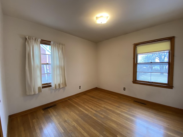 empty room with hardwood / wood-style floors