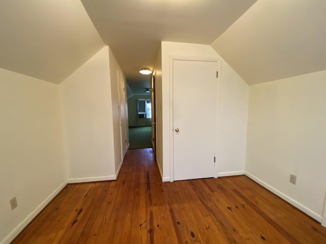 bonus room featuring dark hardwood / wood-style flooring and vaulted ceiling